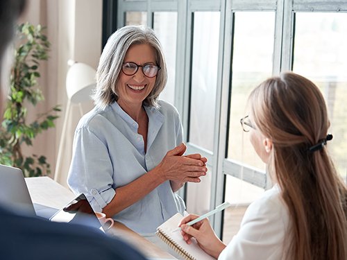 Older woman mentoring a young woman>